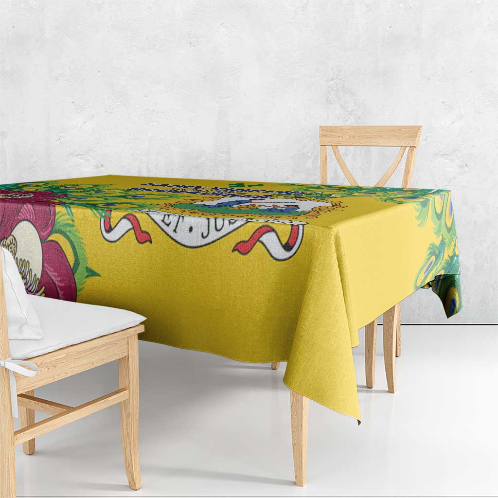 Yellow tablecloth draped over wooden bench with peacock feather and scroll print