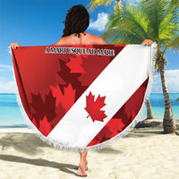 Round red and white beach blanket with Canada text, maple leaf badge, and tassel fringe