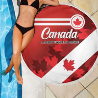 Round beach blanket with Canada flag design, large maple leaf, and white fringe border