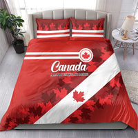 Red Canada bedding set with white diagonal stripe, maple leaf accents, and two pillows