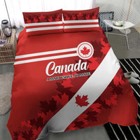 Red Canada bedding set with maple leaf emblem, white stripes, and two matching pillows