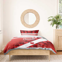 Red Canada comforter with white diagonal stripe and maple leaf print, with two pillow shams