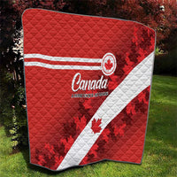Red Canada quilt with white diagonal stripe and maple leaf print, quilted surface