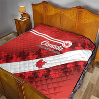 Red Canada quilt on bed with white diagonal stripe and maple leaf graphics