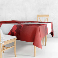 Red tablecloth with white diagonal stripe draped over bench seating