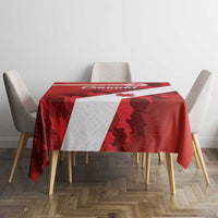 Canada maple leaf tablecloth in red with white stripe and leaf motifs on table