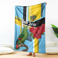 Folded sky blue blanket showing parrot and red roses over yellow, black, and white bands