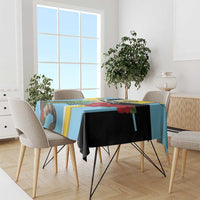 Sky blue tablecloth with black panel and yellow geometric stripes on dining table