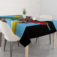 Sky blue tablecloth with black drape and colorful stripe pattern across table