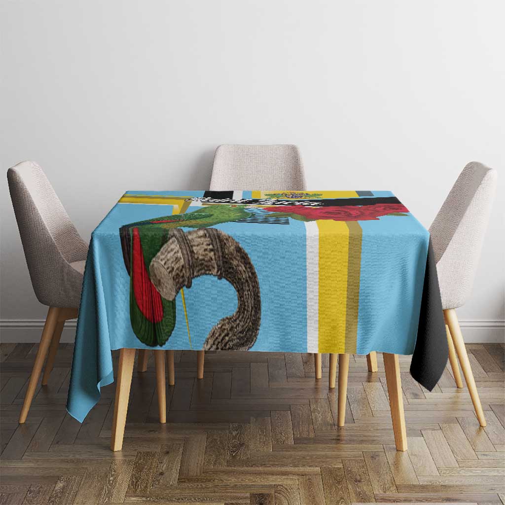 Sky blue tablecloth featuring parrot artwork and multicolor vertical stripes