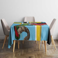 Sky blue tablecloth featuring parrot artwork and multicolor vertical stripes