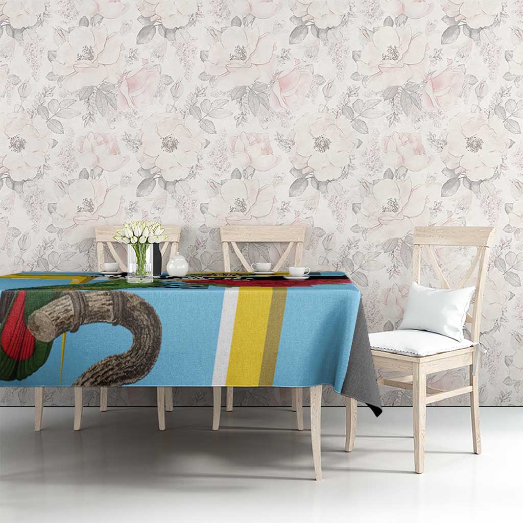 Sky blue tablecloth with parrot and striped border, set on dining table
