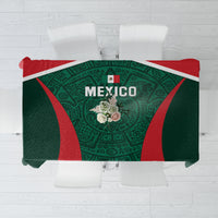 Green tablecloth with red and patterned center, Mexico emblem over tabletop