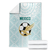 Mint football blanket with eagle-soccer emblem, geometric pattern, with stacked white towels