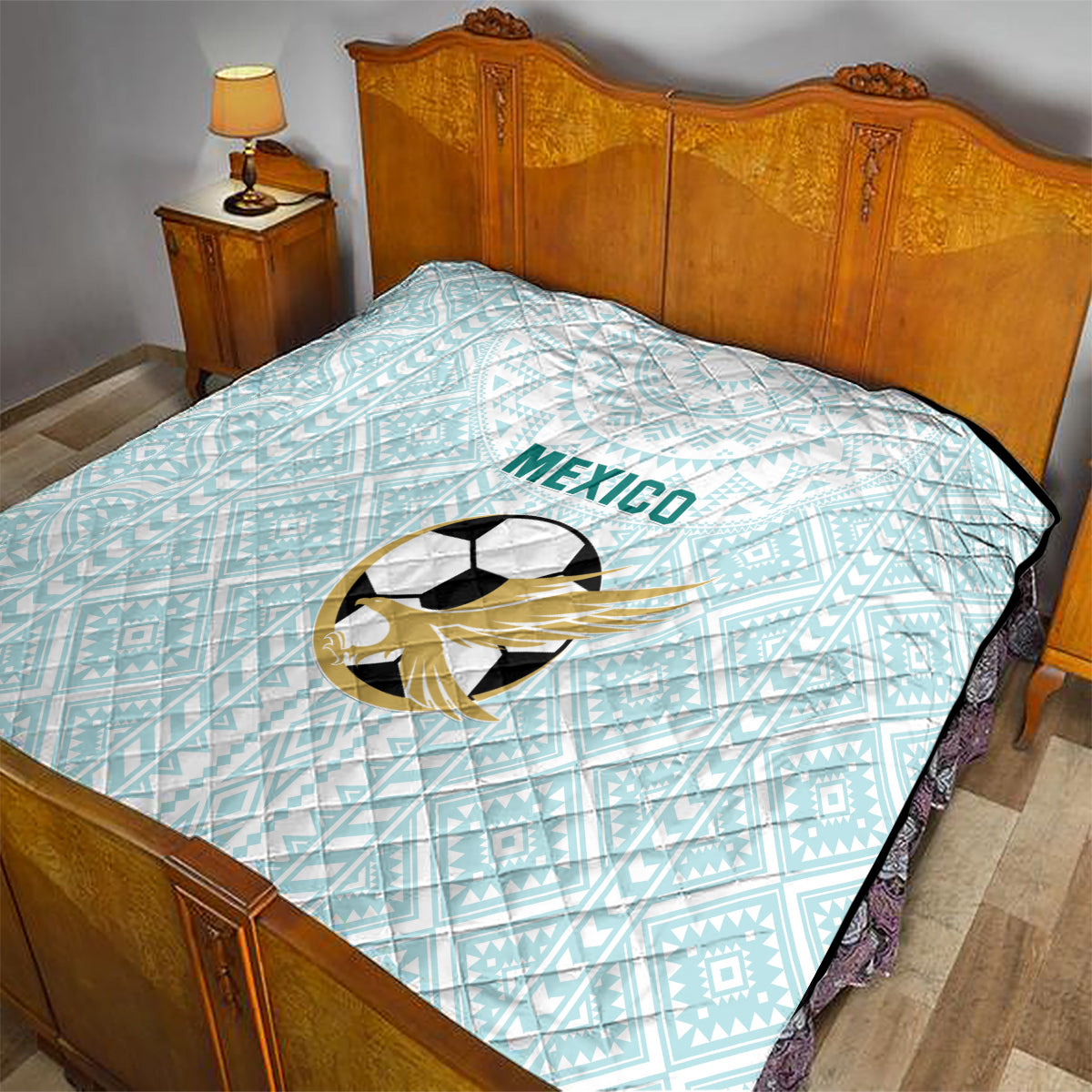 Light blue football quilt on bed with Mexico wordmark and soccer ball emblem