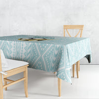 Mint geometric tablecloth draped over a dining table
