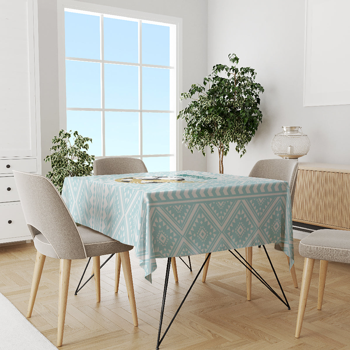 Mint geometric tablecloth covering a dining table with surrounding chairs