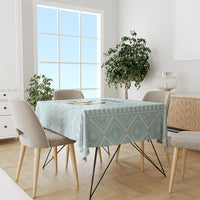 Mint geometric tablecloth covering a dining table with surrounding chairs