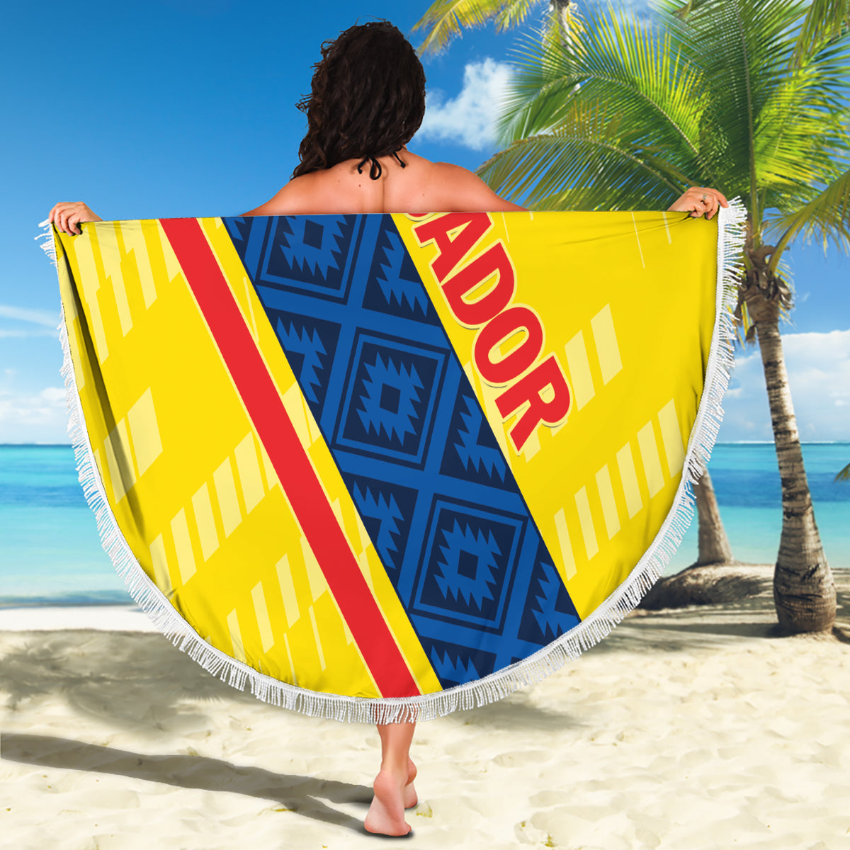 Round Ecuador beach blanket held open, yellow and blue geometric design with red ECUADOR text, fringed