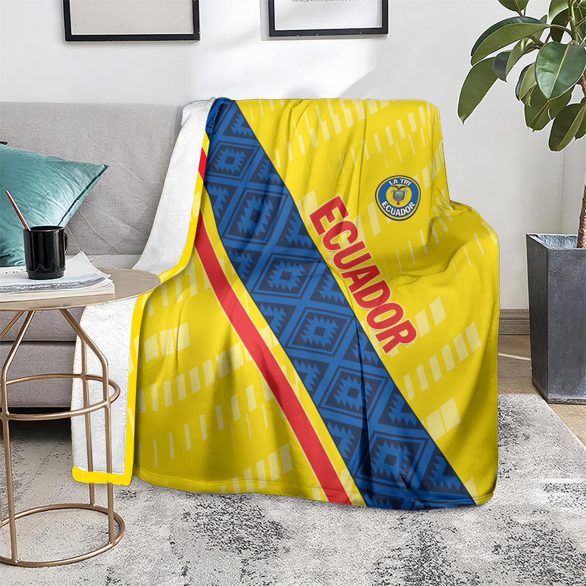 Football blanket on floor, yellow and blue diagonal design with red 'ECUADOR' lettering