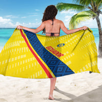 Yellow football sarong spread wide, blue diagonal panel, red stripe, and team crest