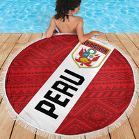 Round beach blanket with red geometric center, white fringe edge, large 'PERU' banner