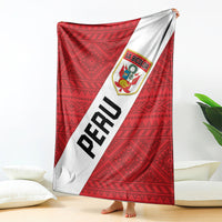 Red football blanket with white diagonal panel, PERU letters and La Bicolor crest