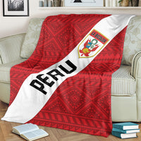 Red football blanket on sofa, PERU text on white diagonal band with La Bicolor crest