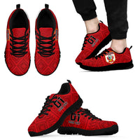 Red lace-up football sneakers with black sole, crest patch, side and front views.