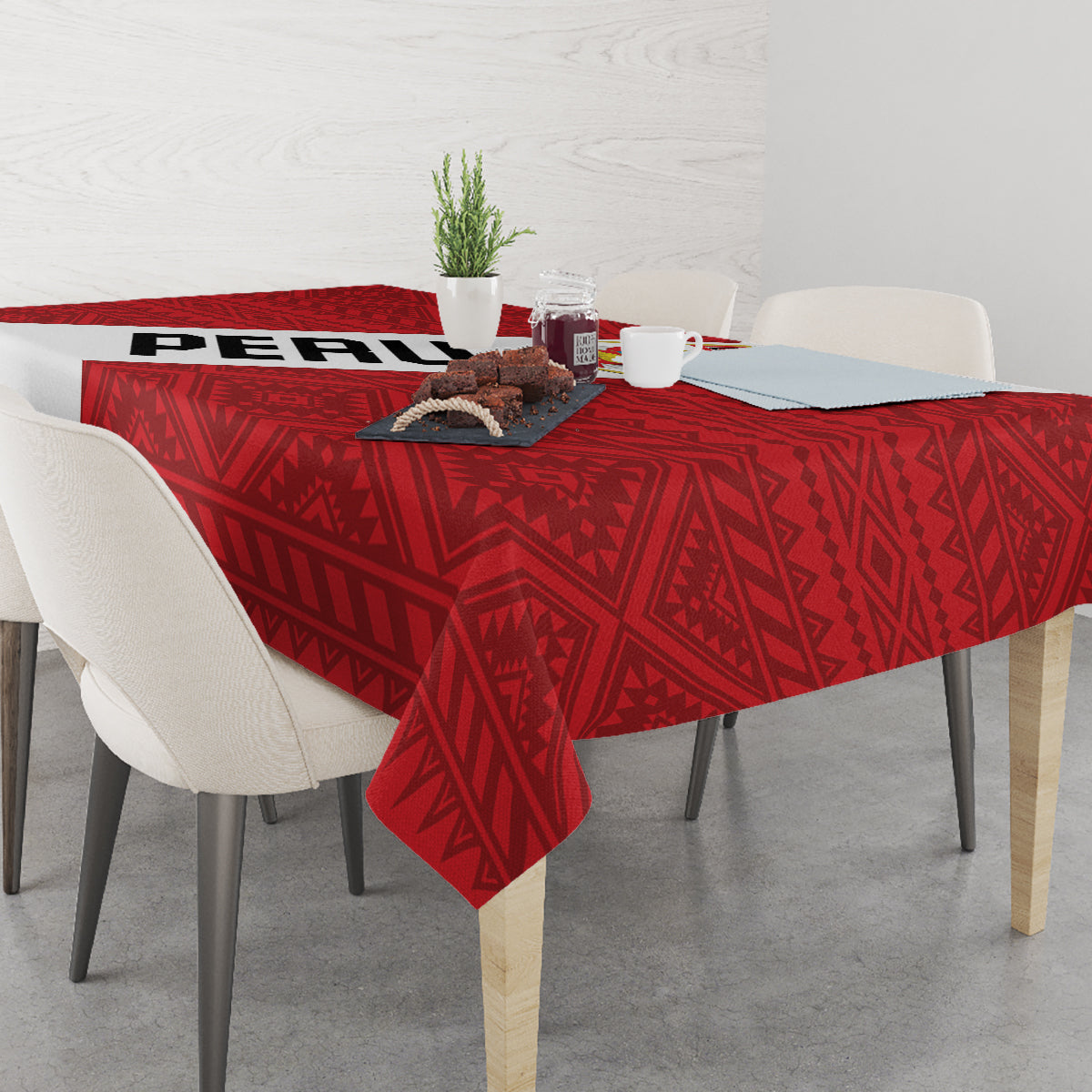 Red football tablecloth with geometric motif draped over dining table with centerpiece