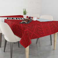 Red football tablecloth with geometric motif draped over dining table with centerpiece