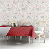 Red football tablecloth with diamond and stripe pattern on white dining chairs