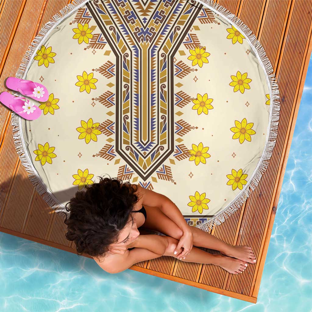 Round beach blanket with fringed border, cream with blue and brown design and yellow flowers