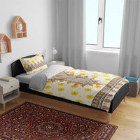 Yellow floral and geometric bedding set on a bed, with two matching pillowcases.
