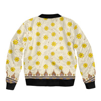 Unisex bomber jacket back with cream base and repeating yellow flower print, ribbed hem and cuffs