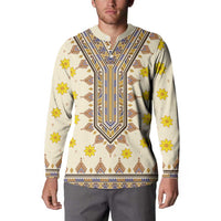 Long-sleeve dashiki sweatshirt on model, off-white with yellow flowers and blue-brown neckline trim