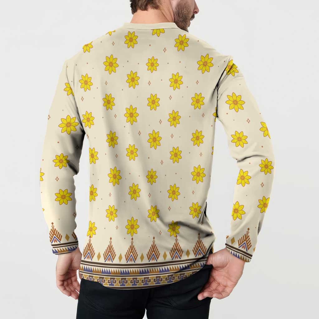 Back of long-sleeve dashiki sweatshirt, off-white with yellow flowers and blue-brown hem pattern