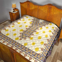 Yellow and white dashiki-style quilt with blue border and geometric pattern flowers