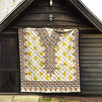 Quilt with yellow floral motifs, blue-trim medallion center, and patterned border