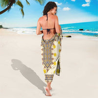 Yellow floral geometric sarong tied at waist, back view