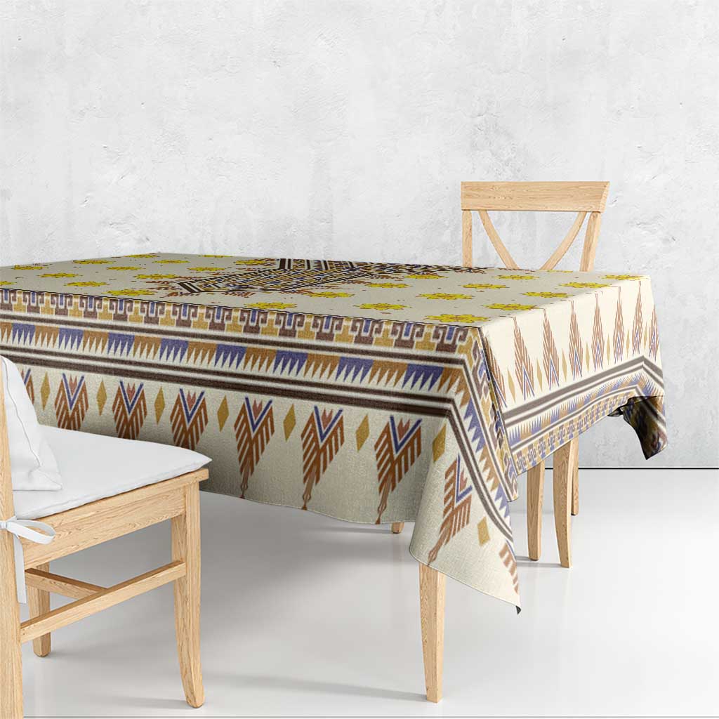 Rectangular yellow tablecloth with blue and brown geometric borders and fringe