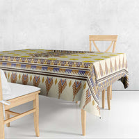 Rectangular yellow tablecloth with blue and brown geometric borders and fringe