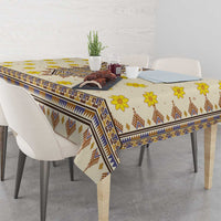 Yellow patterned tablecloth with blue stripe border and brown chevron accents on table