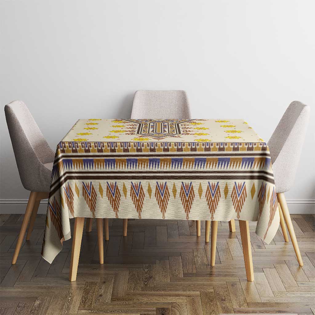 Yellow rectangular tablecloth with blue border, brown chevrons, and yellow floral details