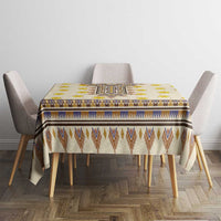 Yellow rectangular tablecloth with blue border, brown chevrons, and yellow floral details