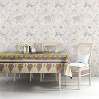 Rectangular yellow tablecloth with blue-and-brown patterned border and yellow floral motifs