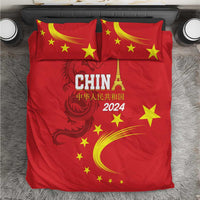 Red bedding set with China 2024 graphic, yellow stars, and dragon emblem