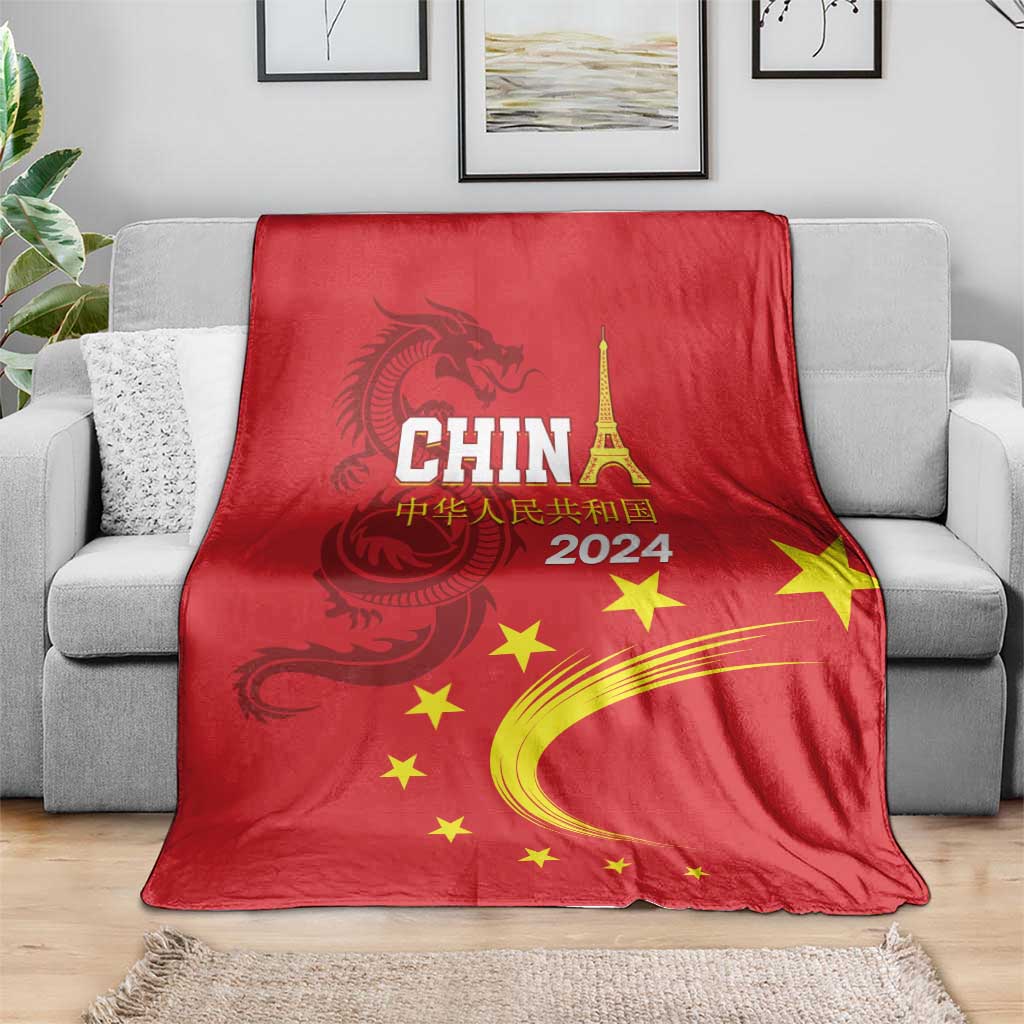 Red China 2024 blanket draped on sofa, CHINA text, dragon emblem, yellow stars