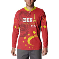 Red button sweatshirt on model, yellow collar, front CHINA 2024 dragon and stars