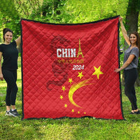 Red quilt with China 2024 text, golden dragon swirl and yellow stars, large square blanket